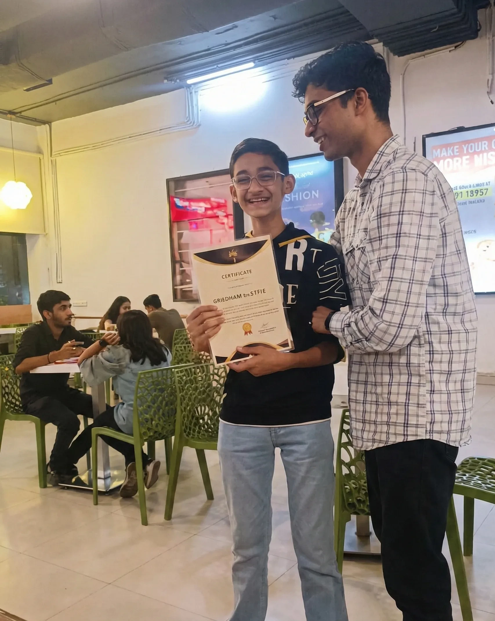 Students receiving Modern Age Coders certificates at the certificate distribution ceremony